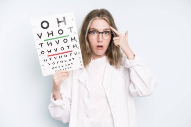 caucasian pretty woman feeling shocked and scared. optical vision test concept
