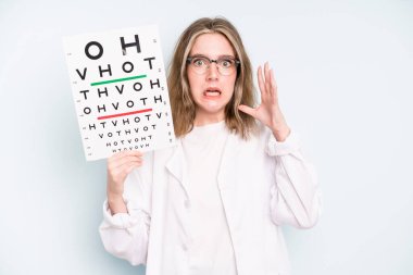 caucasian pretty woman feeling disgusted and irritated and tongue out. optical vision test concept