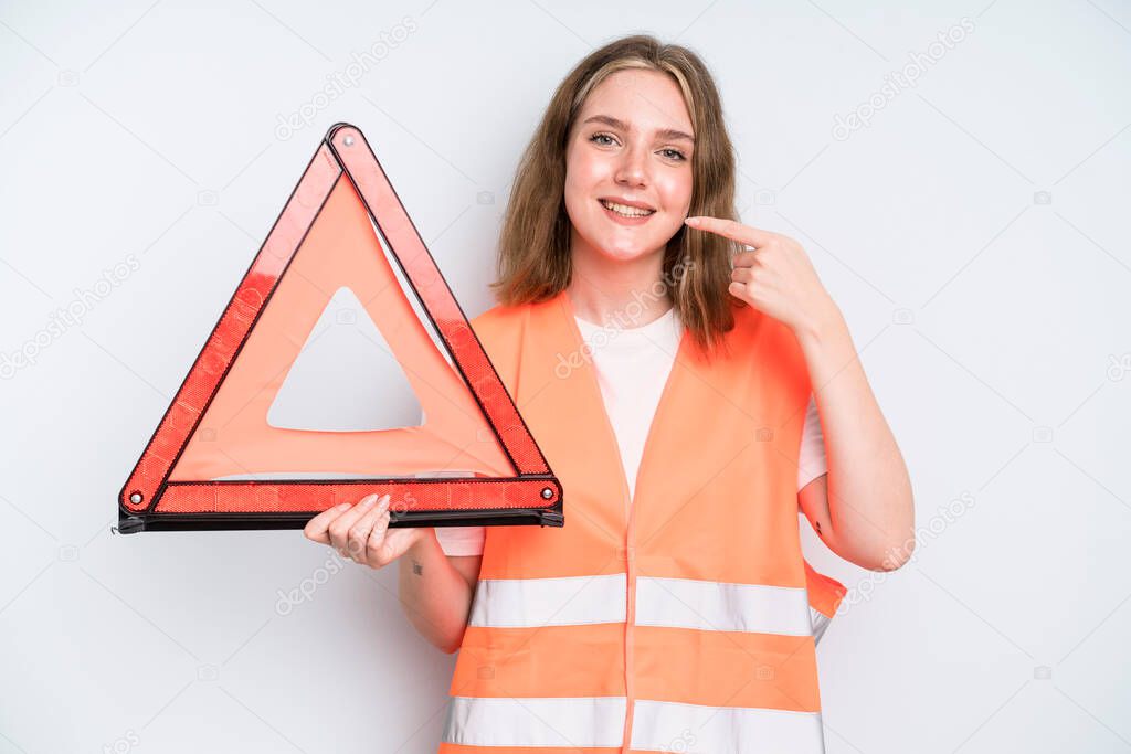 caucasian pretty woman smiling confidently pointing to own broad smile. car emergency concept