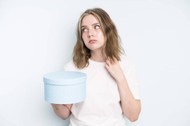 caucasian pretty woman smiling proudly and confidently making number one. gift box concept