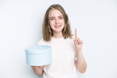 caucasian pretty woman smiling happily, waving hand, welcoming and greeting you. gift box concept