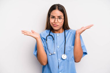 hispanic pretty woman feeling puzzled and confused and doubting. medicine student concept