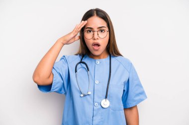 hispanic pretty woman looking happy, astonished and surprised. medicine student concept