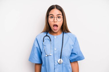 hispanic pretty woman looking very shocked or surprised. medicine student concept