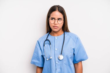 hispanic pretty woman feeling sad, upset or angry and looking to the side. medicine student concept