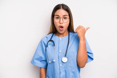 hispanic pretty woman looking astonished in disbelief. medicine student concept