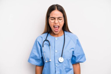 hispanic pretty woman shouting aggressively, looking very angry. medicine student concept