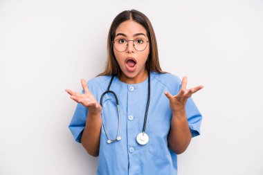 hispanic pretty woman amazed, shocked and astonished with an unbelievable surprise. medicine student concept
