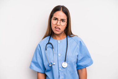 hispanic pretty woman feeling puzzled and confused. medicine student concept