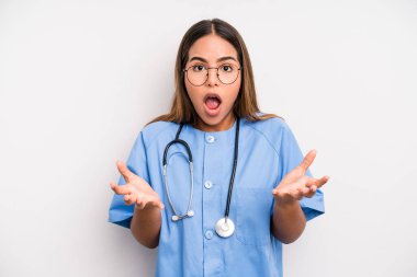 hispanic pretty woman feeling extremely shocked and surprised. medicine student concept
