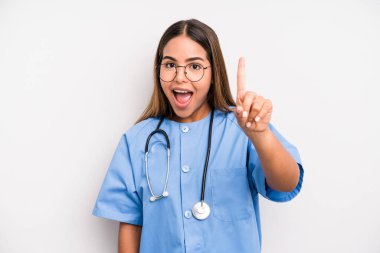 hispanic pretty woman feeling like a happy and excited genius after realizing an idea. medicine student concept