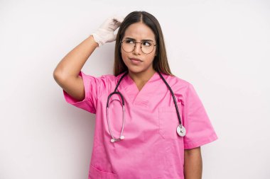 hispanic pretty woman smiling happily and daydreaming or doubting. medicine student concept