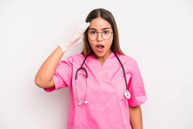 hispanic pretty woman looking happy, astonished and surprised. medicine student concept