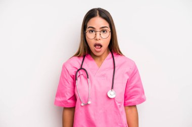 hispanic pretty woman looking very shocked or surprised. medicine student concept