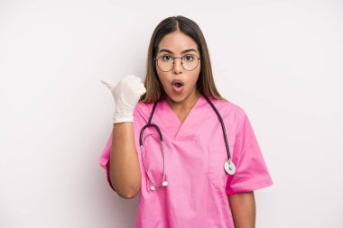 hispanic pretty woman looking astonished in disbelief. medicine student concept