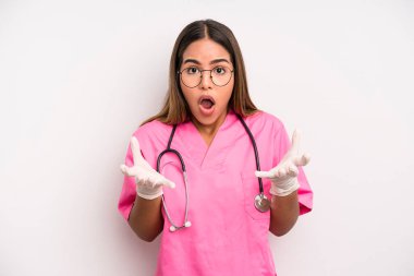 hispanic pretty woman amazed, shocked and astonished with an unbelievable surprise. medicine student concept