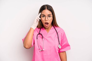 hispanic pretty woman looking surprised, realizing a new thought, idea or concept. medicine student concept