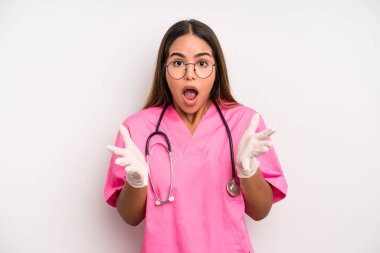 hispanic pretty woman feeling extremely shocked and surprised. medicine student concept