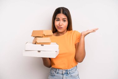hispanic pretty woman feeling puzzled and confused and doubting. fast food and take away concept