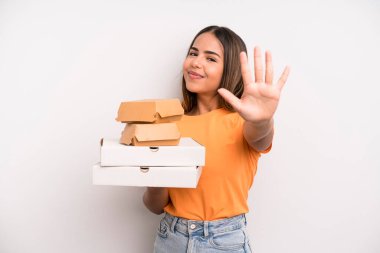 hispanic pretty woman smiling and looking friendly, showing number five. fast food and take away concept