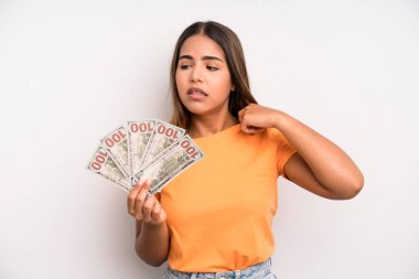 hispanic pretty woman feeling stressed, anxious, tired and frustrated. dollar banknotes savings concept