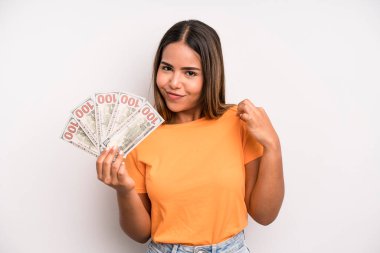 hispanic pretty woman looking arrogant, successful, positive and proud. dollar banknotes savings concept