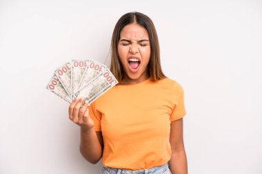hispanic pretty woman shouting aggressively, looking very angry. dollar banknotes savings concept