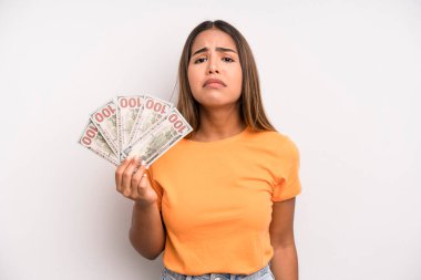 hispanic pretty woman feeling sad and whiney with an unhappy look and crying. dollar banknotes savings concept
