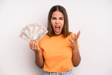 hispanic pretty woman looking desperate, frustrated and stressed. dollar banknotes savings concept