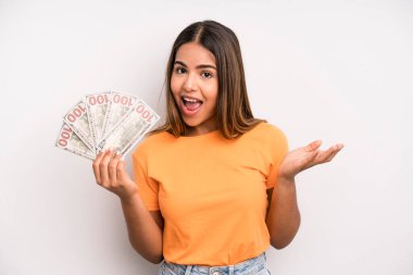 hispanic pretty woman feeling happy, surprised realizing a solution or idea. dollar banknotes savings concept