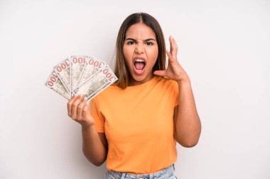 hispanic pretty woman screaming with hands up in the air. dollar banknotes savings concept