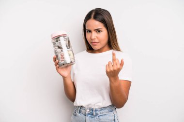 hispanic pretty woman feeling angry, annoyed, rebellious and aggressive. dollar banknotes savings concept