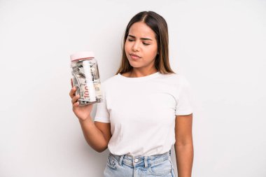 hispanic pretty woman feeling sad, upset or angry and looking to the side. dollar banknotes savings concept