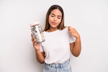 hispanic pretty woman looking arrogant, successful, positive and proud. dollar banknotes savings concept