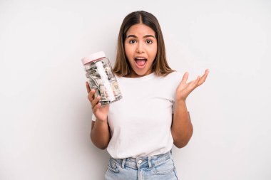 hispanic pretty woman feeling happy, surprised realizing a solution or idea. dollar banknotes savings concept