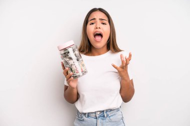 hispanic pretty woman looking desperate, frustrated and stressed. dollar banknotes savings concept