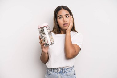 hispanic pretty woman feeling bored, frustrated and sleepy after a tiresome. dollar banknotes savings concept