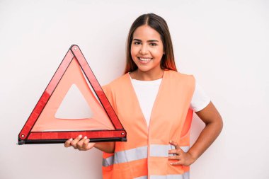 hispanic pretty woman smiling happily with a hand on hip and confident. car accident emergency concept