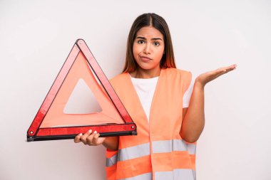 hispanic pretty woman feeling puzzled and confused and doubting. car accident emergency concept