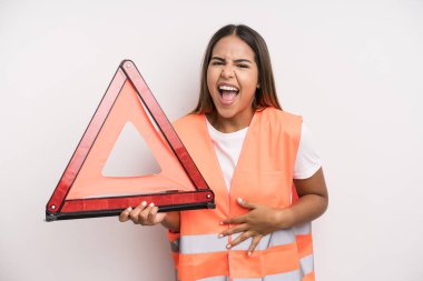 hispanic pretty woman laughing out loud at some hilarious joke. car accident emergency concept