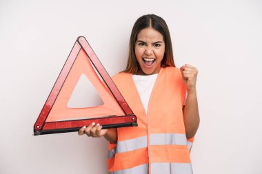 hispanic pretty woman feeling shocked,laughing and celebrating success. car accident emergency concept