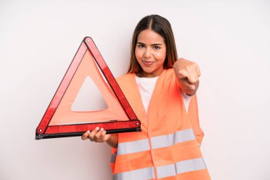 hispanic pretty woman pointing at camera choosing you. car accident emergency concept