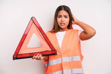 hispanic pretty woman feeling stressed, anxious or scared, with hands on head. car accident emergency concept