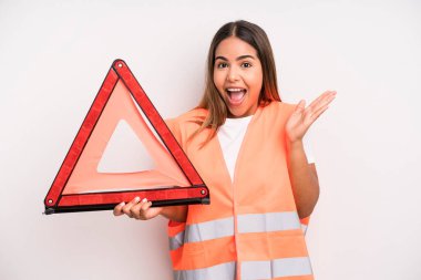hispanic pretty woman feeling happy and astonished at something unbelievable. car accident emergency concept