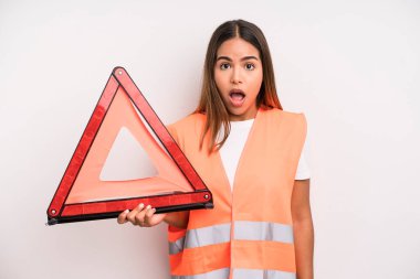 hispanic pretty woman looking very shocked or surprised. car accident emergency concept