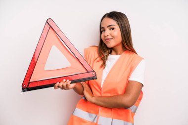 hispanic pretty woman shrugging, feeling confused and uncertain. car accident emergency concept