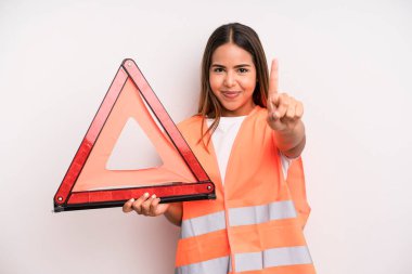 hispanic pretty woman smiling and looking friendly, showing number one. car accident emergency concept