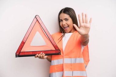 hispanic pretty woman smiling and looking friendly, showing number five. car accident emergency concept