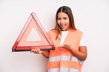 hispanic pretty woman smiling cheerfully, feeling happy and showing a concept. car accident emergency concept