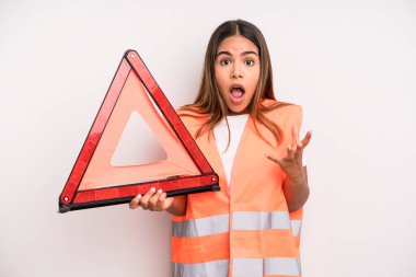 hispanic pretty woman amazed, shocked and astonished with an unbelievable surprise. car accident emergency concept